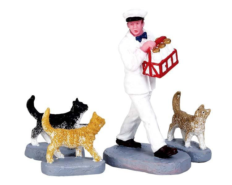 Figura de gatos tras el lechero